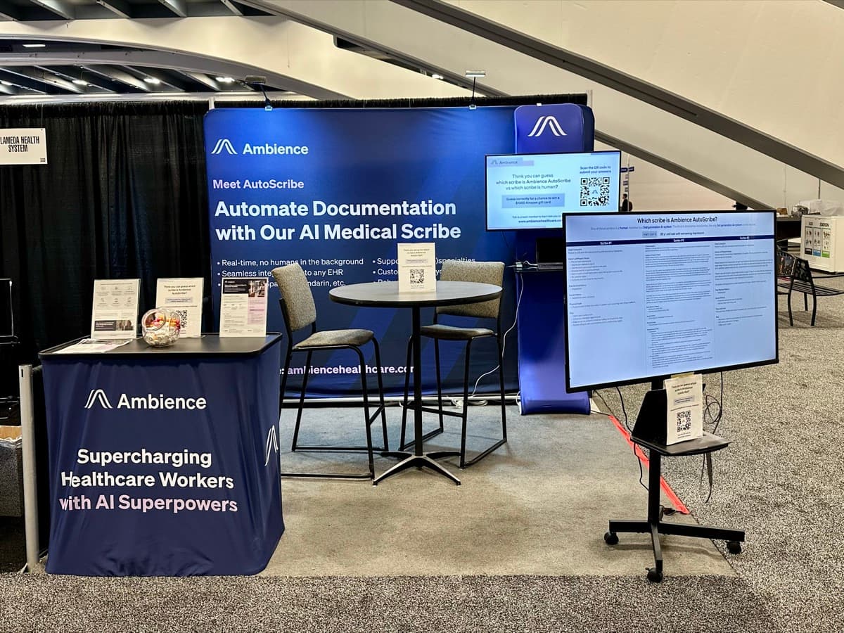 Ambience Healthcare booth showing product demo screens