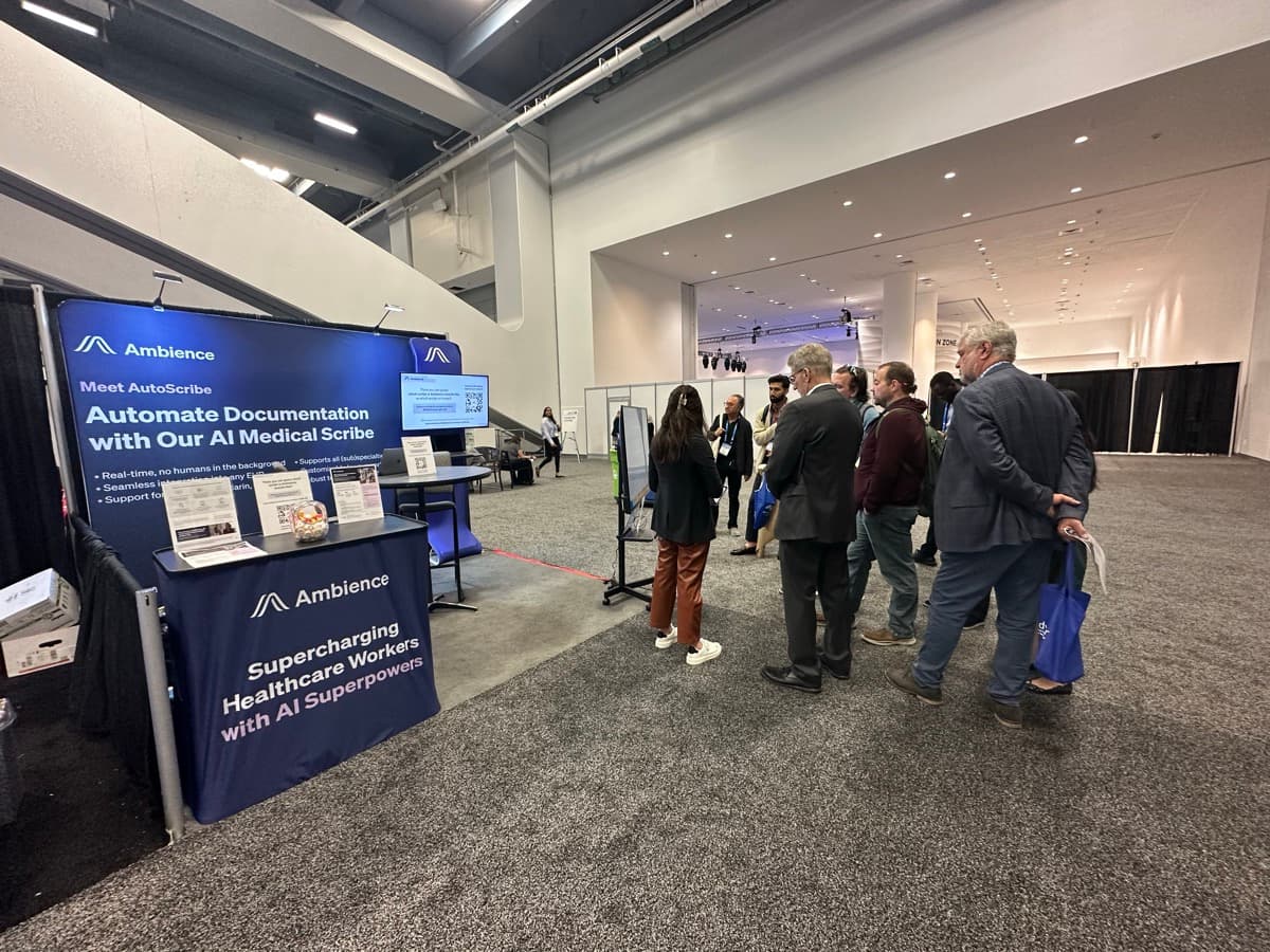 Ambience Healthcare booth with attendees gathered around