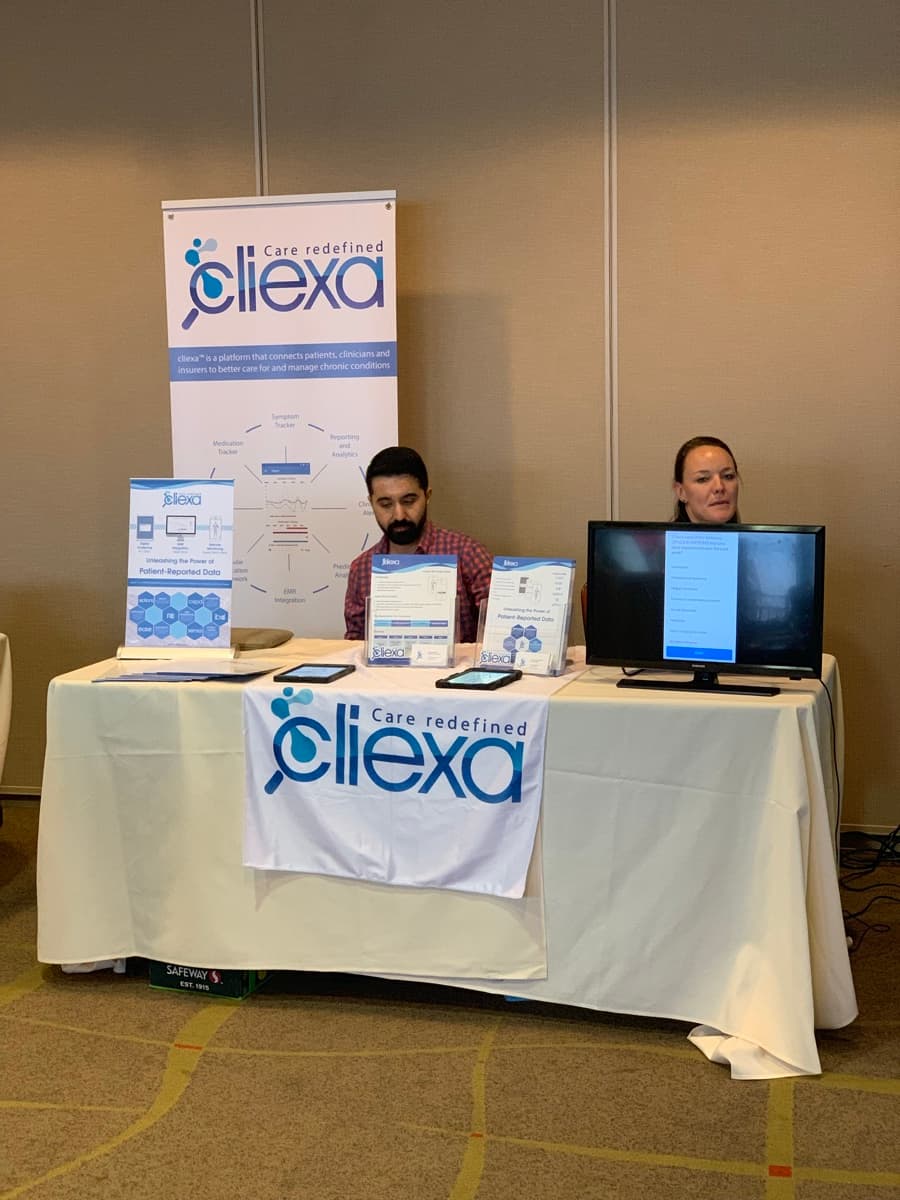 cliexa booth at healthcare conference with demo stations