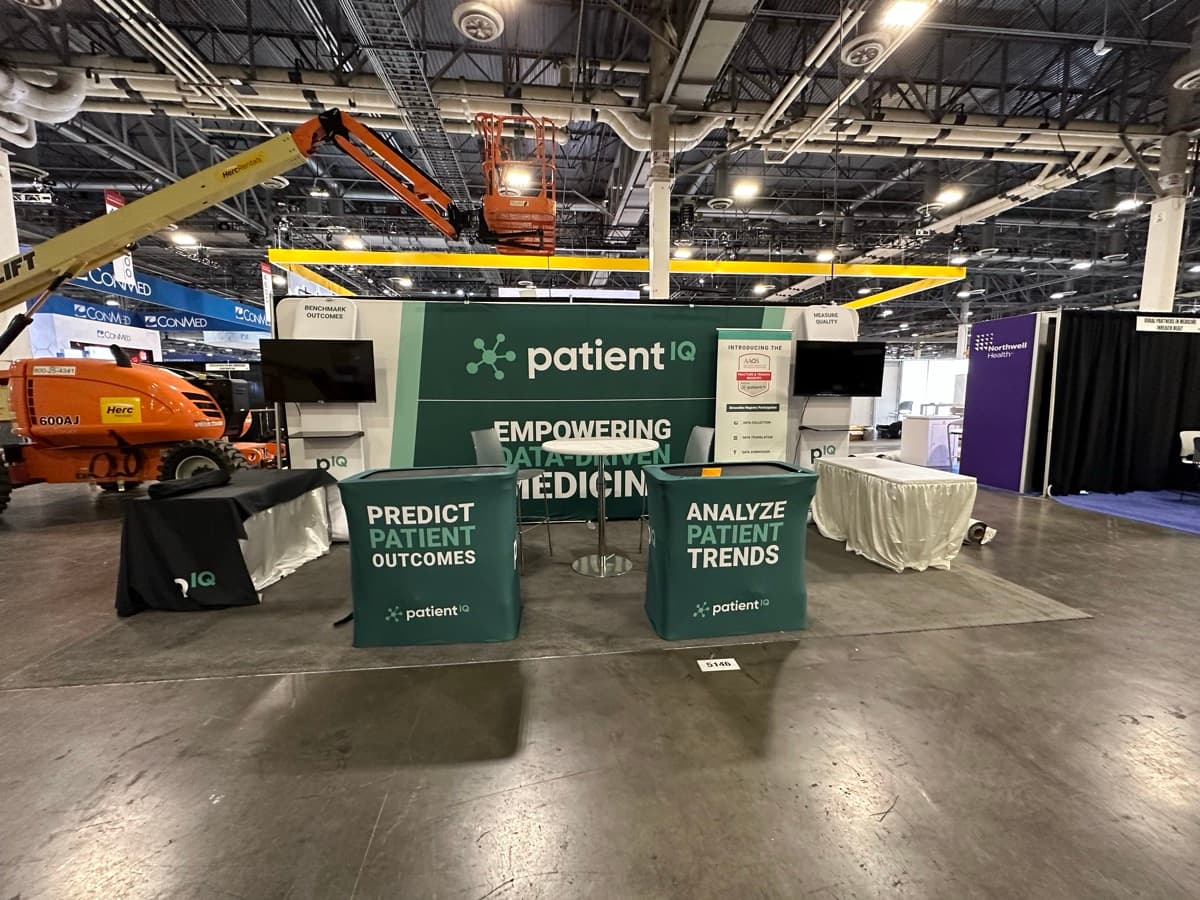 PatientIQ booth at AAOS conference with 'Empowering Data-Driven Medicine' banner